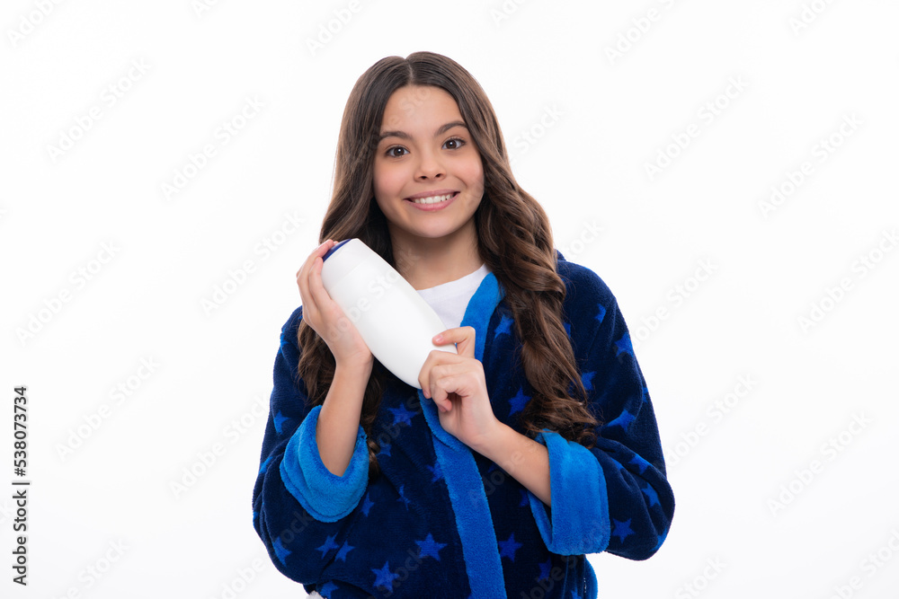 Teenager child girl showing bottle shampoo conditioners or shower gel. Hair cosmetic product. Bottle for advertising mock up copy space. Happy girl face, positive and smiling emotions. Teenager child girl showing bottle shampoo conditioners or shower gel. Hair cosmetic product. Bottle for advertising mock up copy space. Happy girl face, positive and smiling emotions.
