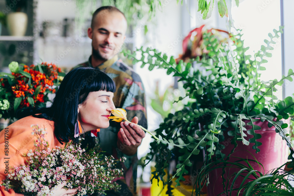 Woman and man work in florist shop.