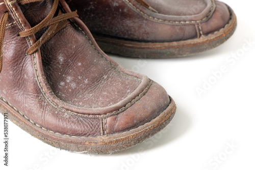 Fungus on brown leather boots shoes isolated on white