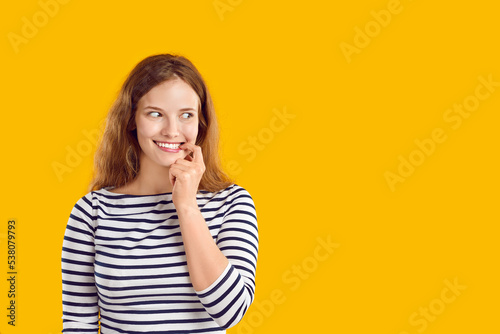 Foto Young woman looks aside with funny awkward smile on face