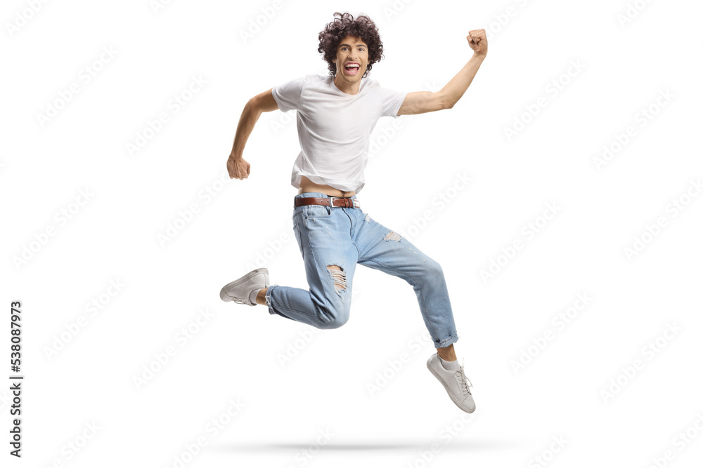 Casual young man jumping with happiness