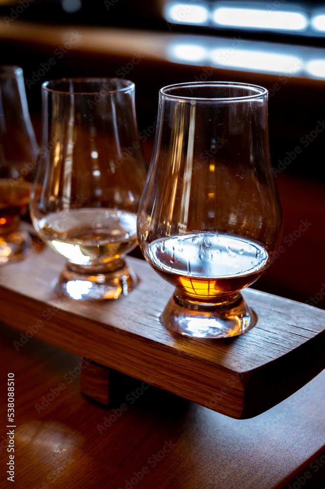 Flight of single malt scotch whisky in glasses served in whiskey bar in Edinburgh, UK Flight of single malt scotch whisky in glasses served in whiskey bar in Edinburgh, UK