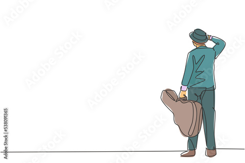 One single line drawing of young happy male guitarist standing and holding acoustic guitar case. Dynamic musician artist concept continuous line graphic draw design vector illustration