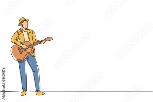 One continuous line drawing of young happy male guitarist wearing hat and playing acoustic guitar on street road. Trendy musician artist performance concept single line draw design vector illustration