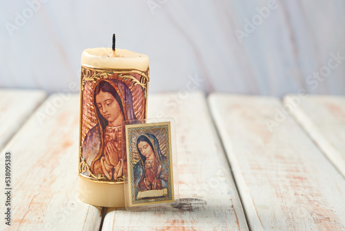 Candleholder and holy card with the image of the virgin of guadalupe of mexico. photo