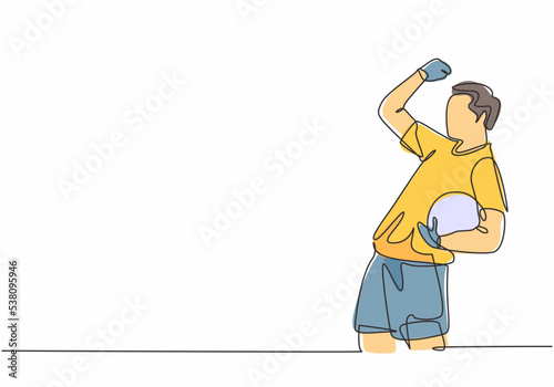One continuous line drawing of young soccer player celebrating goal keeping ball on his hand and punching fist to the sky. Goal scoring celebration concept single line draw design vector illustration