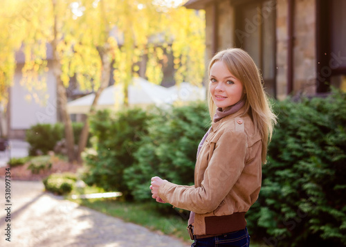 Portrait of a beautiful blonde woman outdoors in autumn.