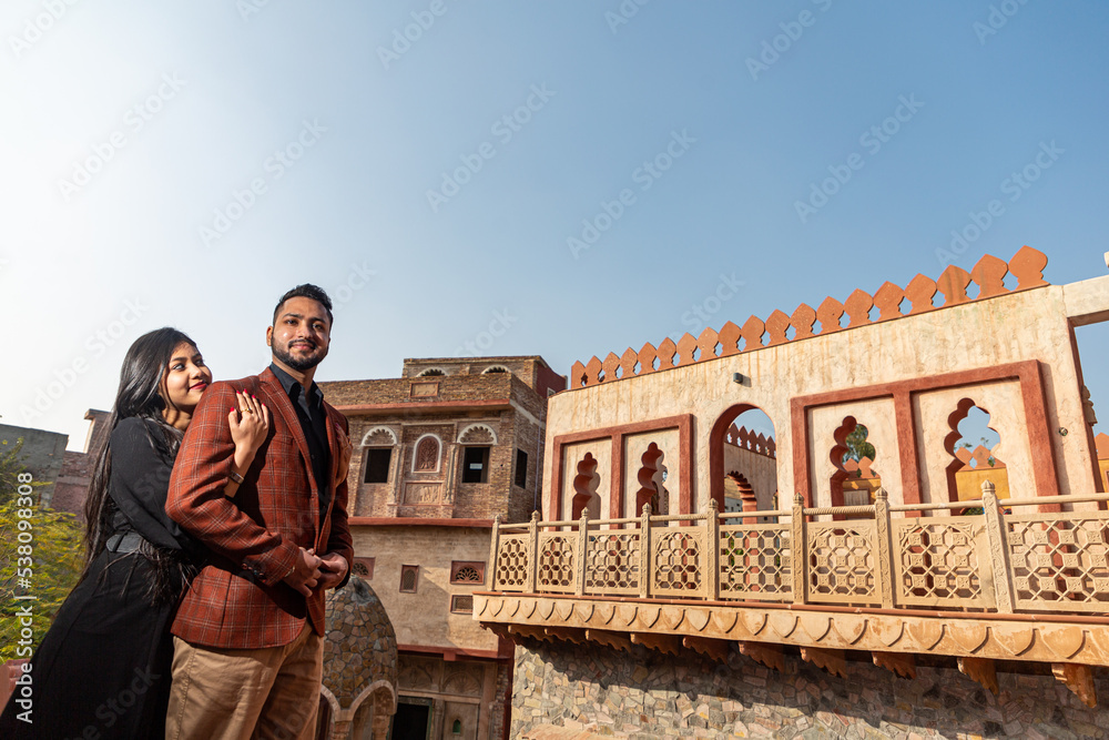A young Indian couple shooting their pre wedding at a heritage fort in Delhi India. Romantic couple having shoot Delhi. Best young couple India. Pre wedding Indian couple.