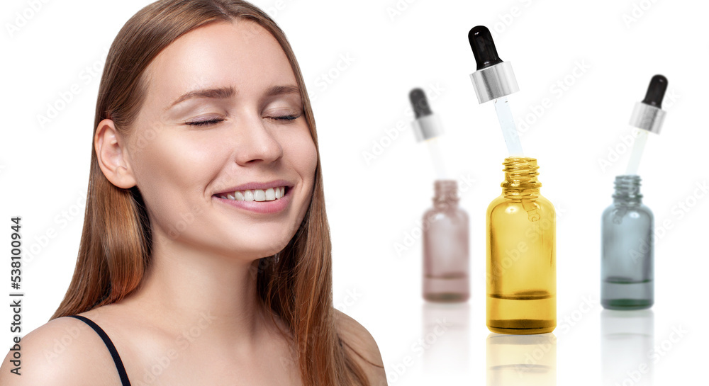 Cosmetics oil in bottles near beautiful face of young woman. Cosmetics oil in bottles near beautiful face of young woman.