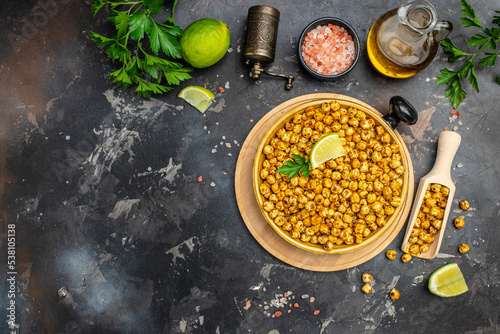 fried chickpeas on a dark background. Traditional Indian cuisine. Tasty vegetarian and vegan chickpea snack. banner, menu, recipe place for text, top view