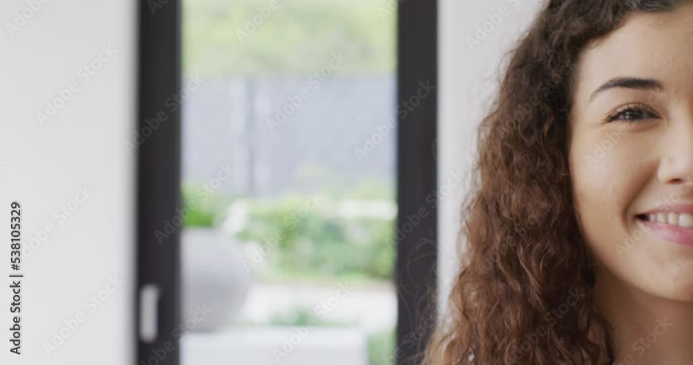 Video portrait of happy biracial woman smiling to camera indoors, with copy space Video portrait of happy biracial woman smiling to camera indoors, with copy space