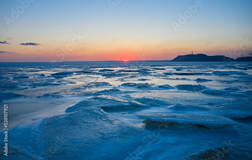 Картината върху платно Aerial view of sunset over the frozen sea