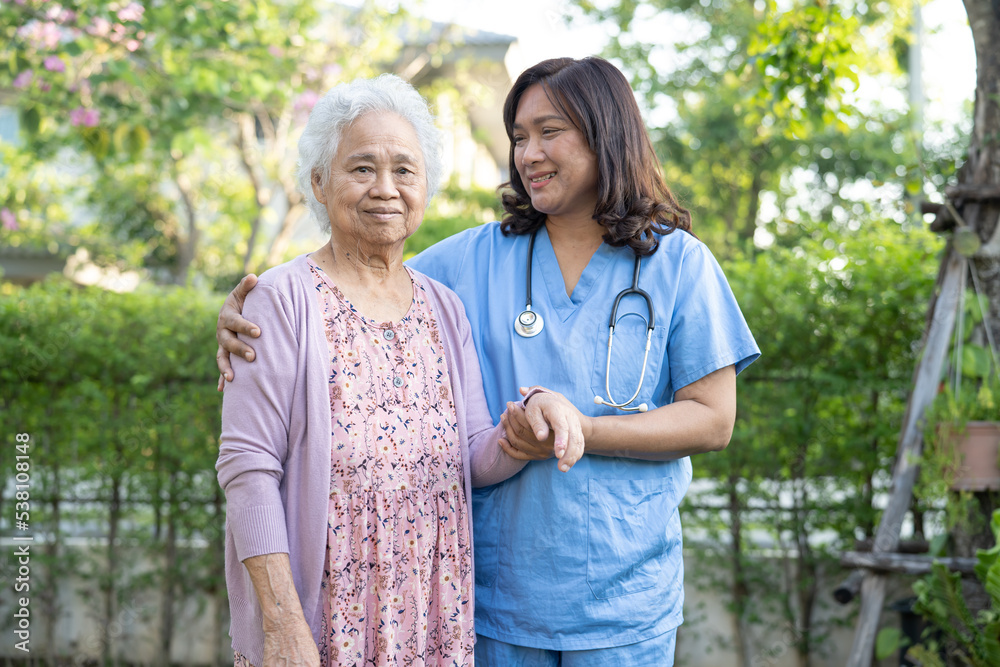 Doctor help and care Asian senior or elderly old lady woman use walker with strong health while walking at park in happy fresh holiday. Doctor help and care Asian senior or elderly old lady woman use walker with strong health while walking at park in happy fresh holiday.