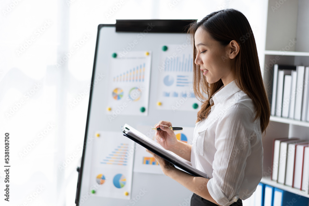 Beautiful Asian business woman working at the office With financial report. Beautiful Asian business woman working at the office With financial report.