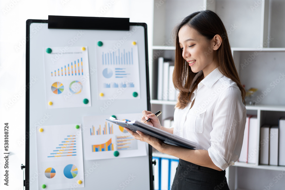 Beautiful Asian business woman working at the office With financial report. Beautiful Asian business woman working at the office With financial report.
