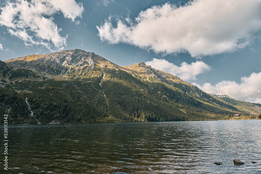 The beauty of nature concept background. Fantastic panorama of Tatra mountains and Lake with turquoise color in Poland. Picturesque sunset in the Mountains of Europe. The beauty of nature concept background. Fantastic panorama of Tatra mountains and Lake with turquoise color in Poland. Picturesque sunset in the Mountains of Europe.