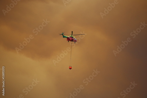 Un helicoptero ayudando extinquir un fuego