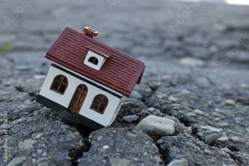 Vászonkép House model in cracked asphalt. Earthquake disaster