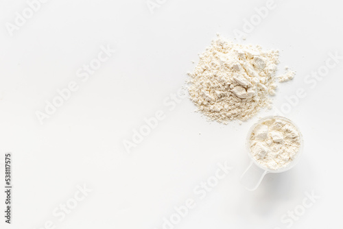 Scoop with whey protein powder. Sport food supplement and gym diet photo