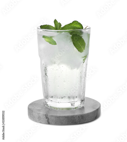 Glass of refreshing drink with mint and stylish stone cup coaster isolated on white