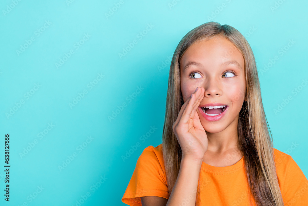 Fototapeta premium Closeup photo of cute young schoolkid girl blonde hair rumor hand secret information looking empty space speaking isolated on cyan color background