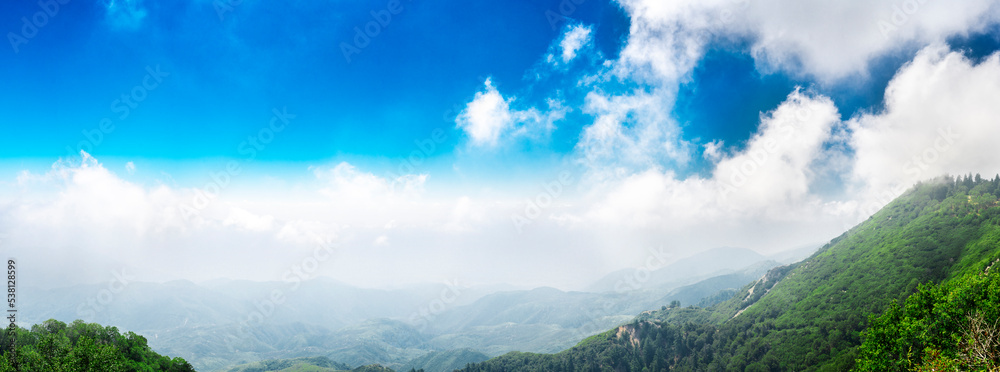 Beautiful mountain panorama. Epic view over high mountains with amazing blue sky and clouds above the peaks. Beautiful mountain panorama. Epic view over high mountains with amazing blue sky and clouds above the peaks.