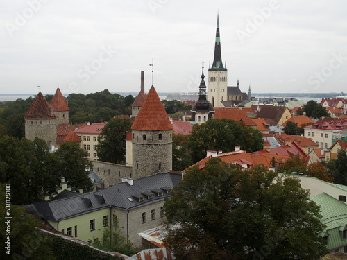 View of Tallinn, Estonia, with the towers of the city wall in the middle and the Tower of Olai Church in the background