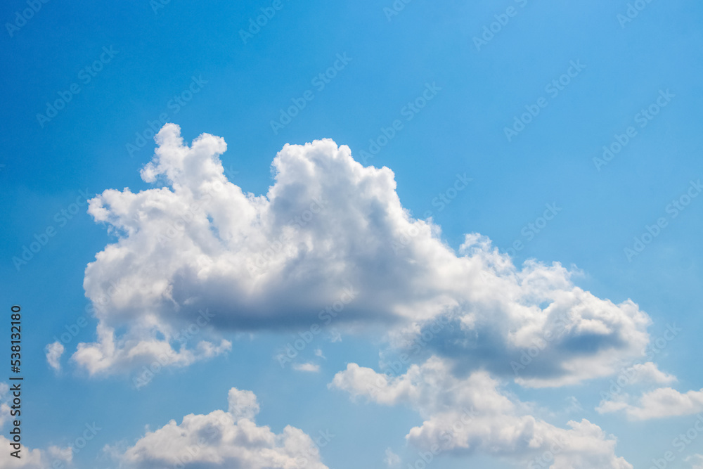 Sunlit white clouds in the blue sky