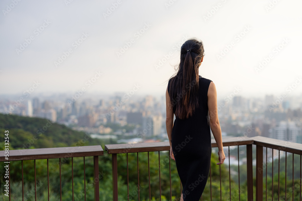 Businesswoman look at the city on mountain Businesswoman look at the city on mountain