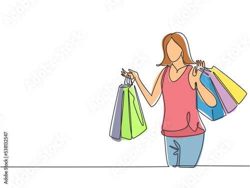 One continuous line drawing young happy beauty woman holding many paper bags after shopping personal needs. Shopping fashion, cosmetic, makeup in big mall concept. Single line draw design illustration