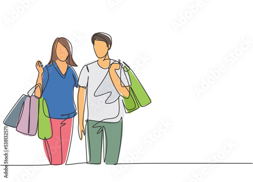 Single continuous line drawing young happy romantic couple holding paper bags while shopping together at mall. Buying fashion and cosmetic concept. One line draw vector graphic design illustration