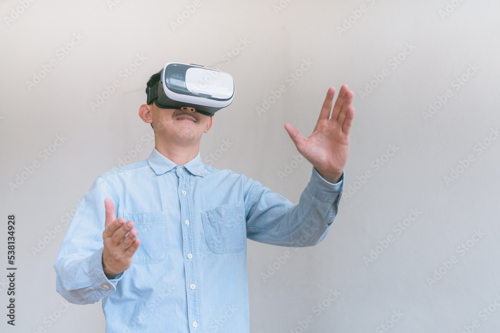 business man using virtual reality headset. Isolated on gray background studio portrait. VR, future, technology, education online, studying . Studio shot on gray business man using virtual reality headset. Isolated on gray background studio portrait. VR, future, technology, education online, studying . Studio shot on gray