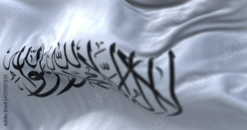 The flag of the Islamic Emirate of Afghanistan waving in the wind.