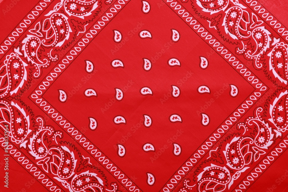 Top view of red bandana with paisley pattern as background Stock