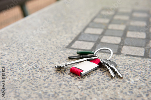 Konstfotografi Keys forgotten on grey stone table outdoors