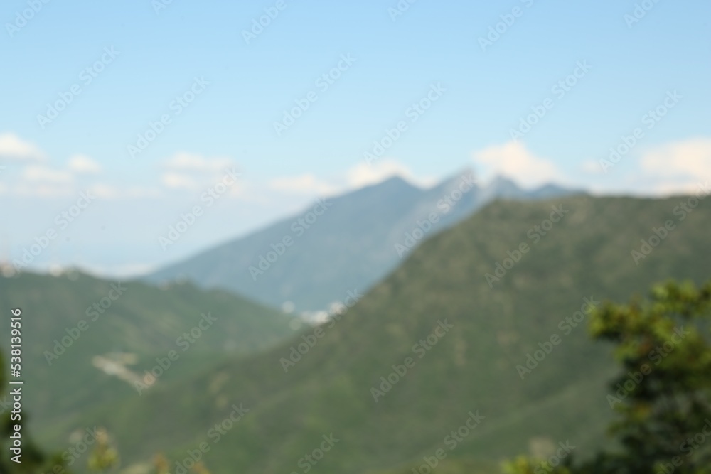 Big mountains under cloudy sky, blurred view