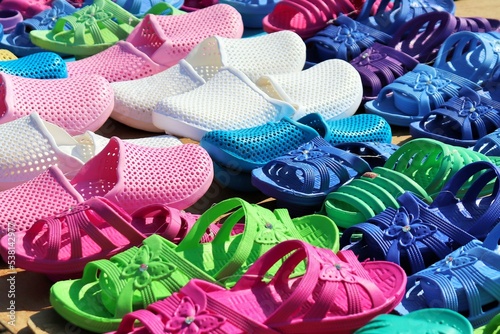 Bright cheap plastic shoes on the counter of a street vendor