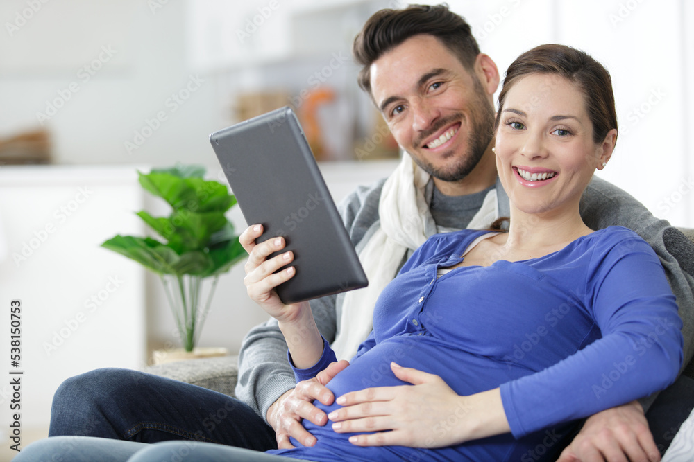 cheerful couple using digital tablet at home cheerful couple using digital tablet at home