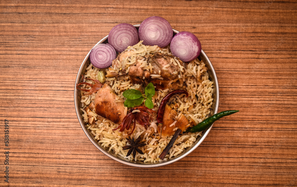 Delicious mutton biryani top view.Biryani rice dish Beautiful Indian rice dish.Delicious spicy chicken biryani in bowl over moody background, it’s a popular Indian and Pakistani food. Delicious mutton biryani top view.Biryani rice dish Beautiful Indian rice dish.Delicious spicy chicken biryani in bowl over moody background, it’s a popular Indian and Pakistani food.
