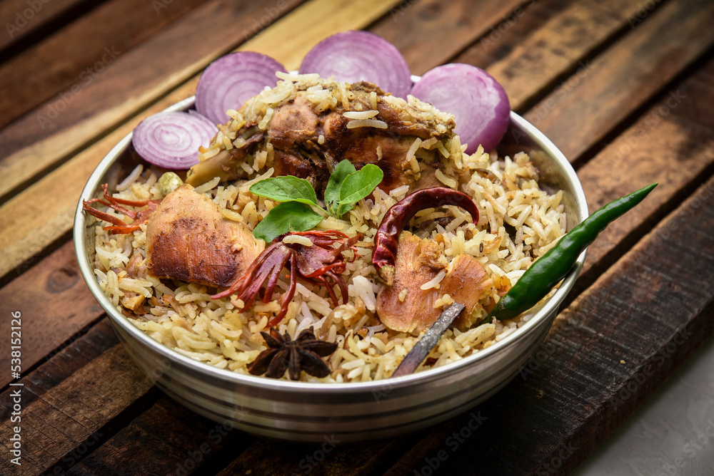 Delicious mutton biryani top view.Biryani rice dish Beautiful Indian rice dish.Delicious spicy chicken biryani in bowl over moody background, it’s a popular Indian and Pakistani food. Delicious mutton biryani top view.Biryani rice dish Beautiful Indian rice dish.Delicious spicy chicken biryani in bowl over moody background, it’s a popular Indian and Pakistani food.