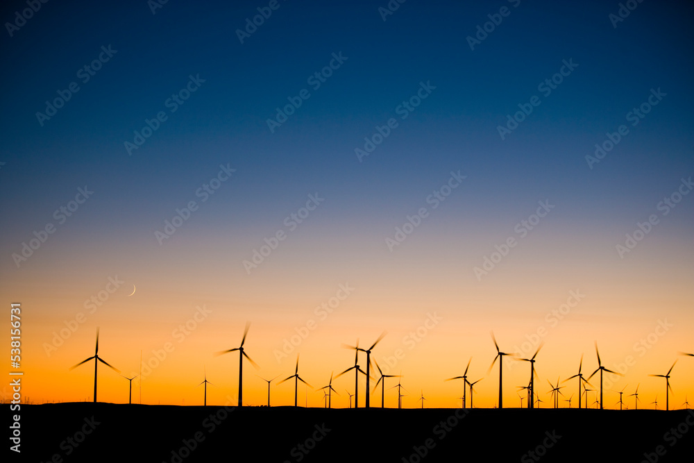 Twilight Sky with wind turbine silhouettes on the horizon