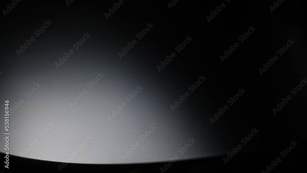 Black background with light shining on it. Black background with light shining on it.