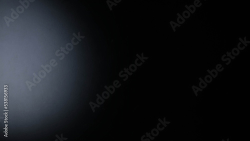 Black background with light shining on it.