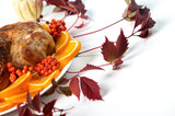 Festive celebration roasted chicken with orange slices and rowan berries for Thanksgiving or Christmas dinner. Selective focus with copy space