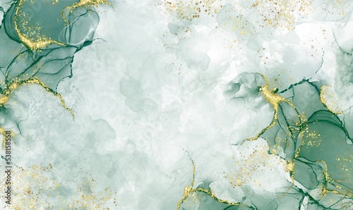Green watercolor background drawn by brush. Green paints spilled on paper. Golden shiny christmas and Liquid marble texture. Fluid art luxury wallpaper for design, print, invitation
