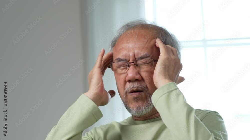 Asian Senior elderly old man feel headache suffering and migraine in living room at home. Stressed mature male hurt mental health care and insurance concept. Asian Senior elderly old man feel headache suffering and migraine in living room at home. Stressed mature male hurt mental health care and insurance concept.