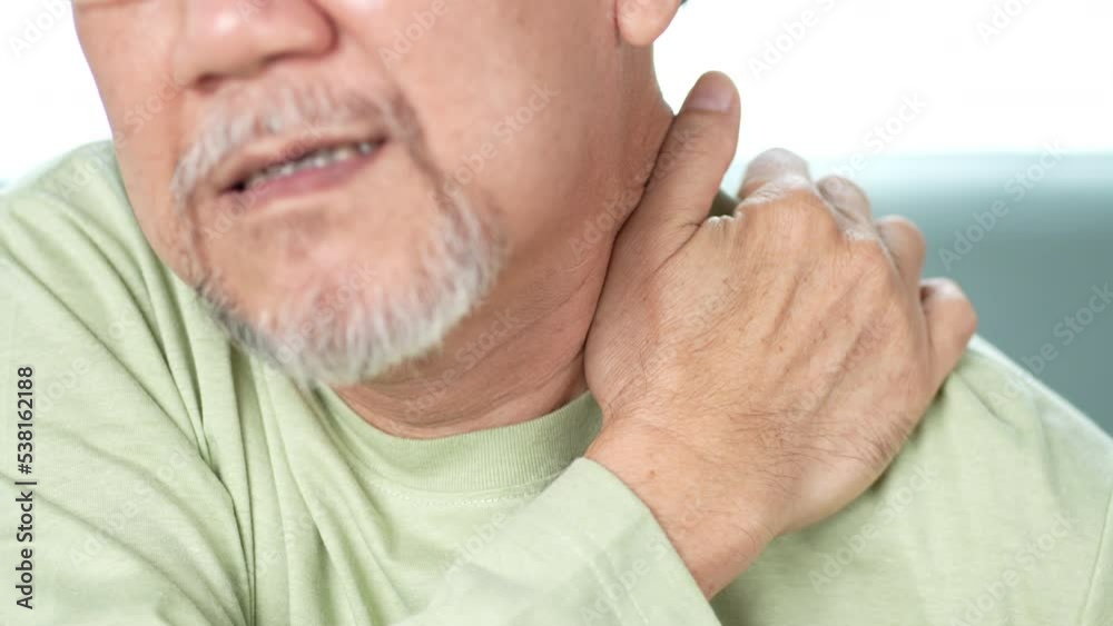 Asian Senior elderly man feek neckache his touching neck pain. Streesed old male suffer while sit on sofa at home. Health care and insurance retirement concept. Asian Senior elderly man feek neckache his touching neck pain. Streesed old male suffer while sit on sofa at home. Health care and insurance retirement concept.