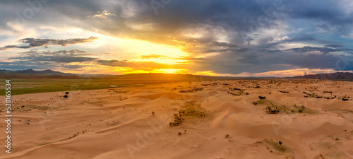 Sand dunes in desert at sunset photo