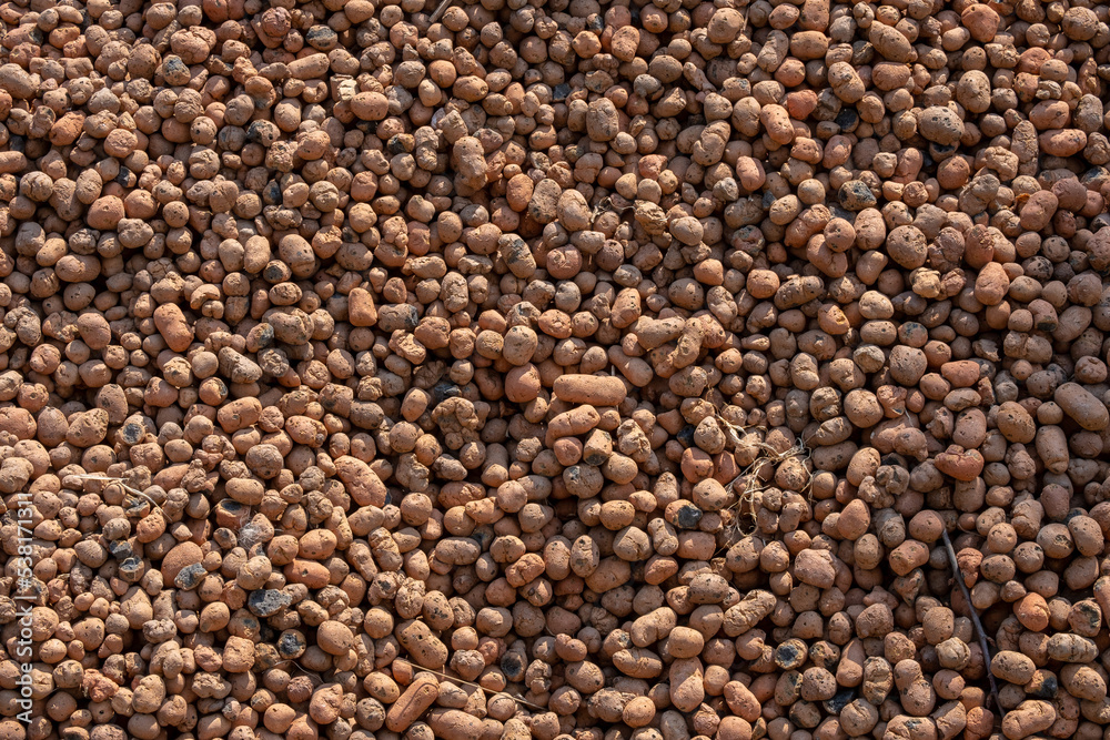 Top view of expanded clay texture background in sunlight. Top view of expanded clay texture background in sunlight.
