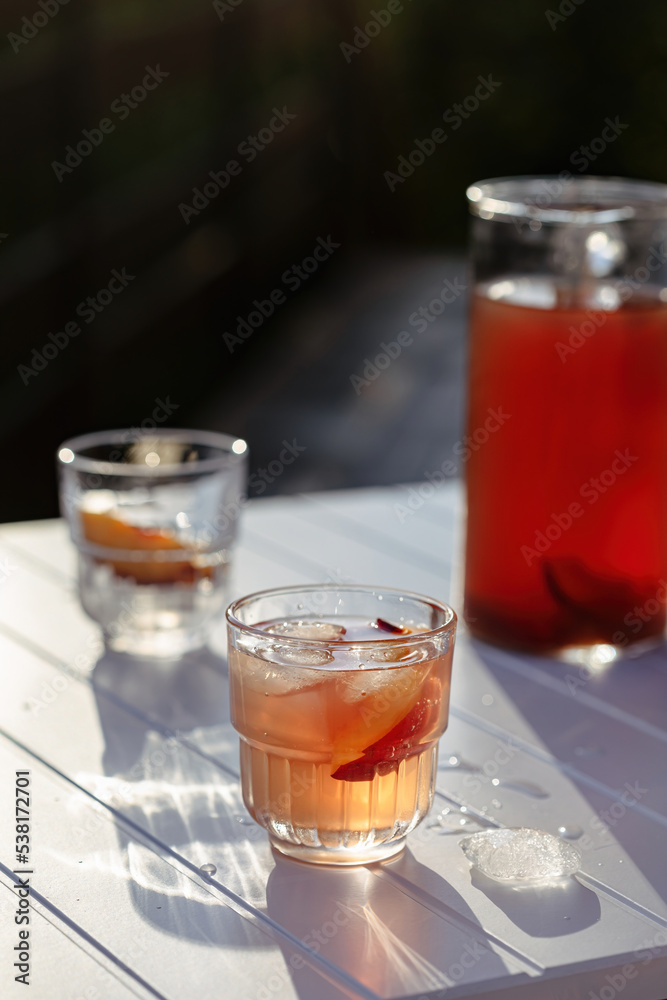 Iced peach tea with ice on a hot summer day Iced peach tea with ice on a hot summer day